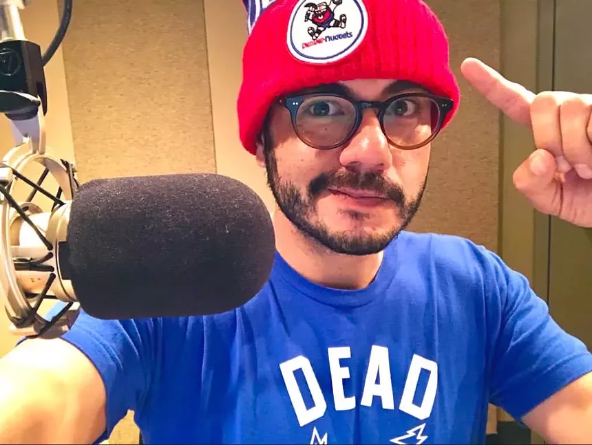 Man in red beanie in front of microphone