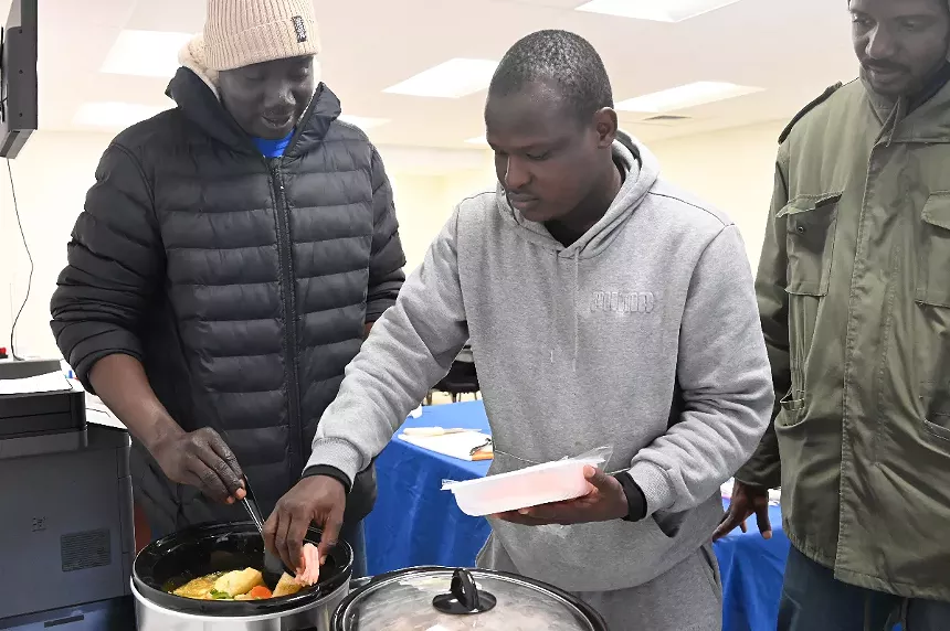 A man adds meat to a soup.