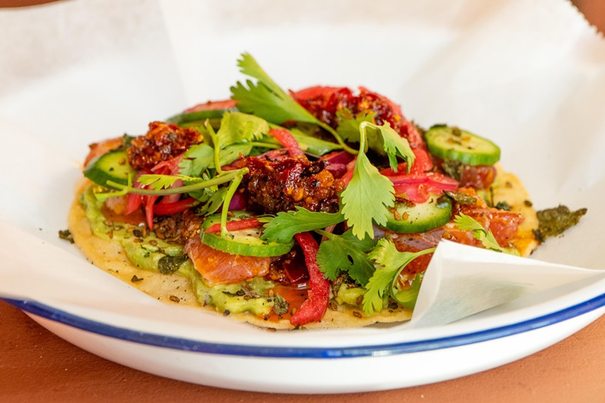 a tostada with avocado, cucumber, red onions and toasted nori.
