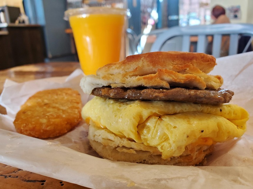 a sausage, egg and cheese biscuit sandwich and a hash brown