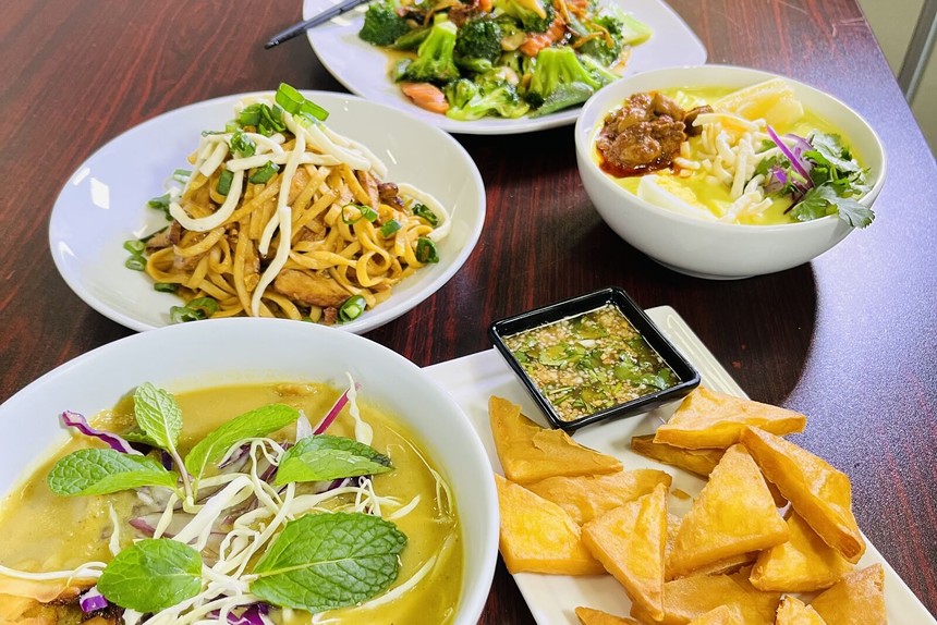 Burmese noodles, soup and other dishes on a table