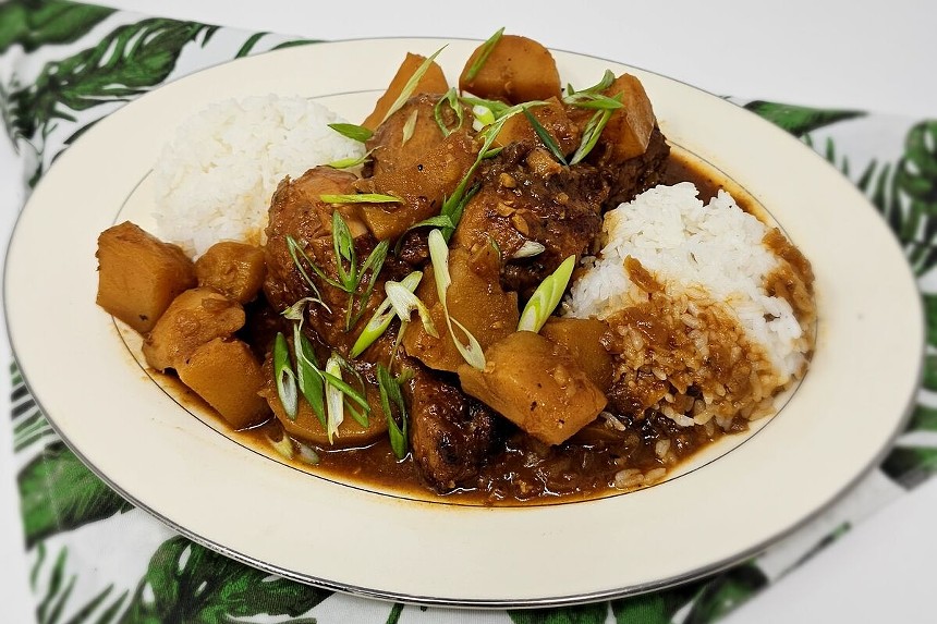 A Filipino stew served over rice from The Sweet Life Culinary Productions