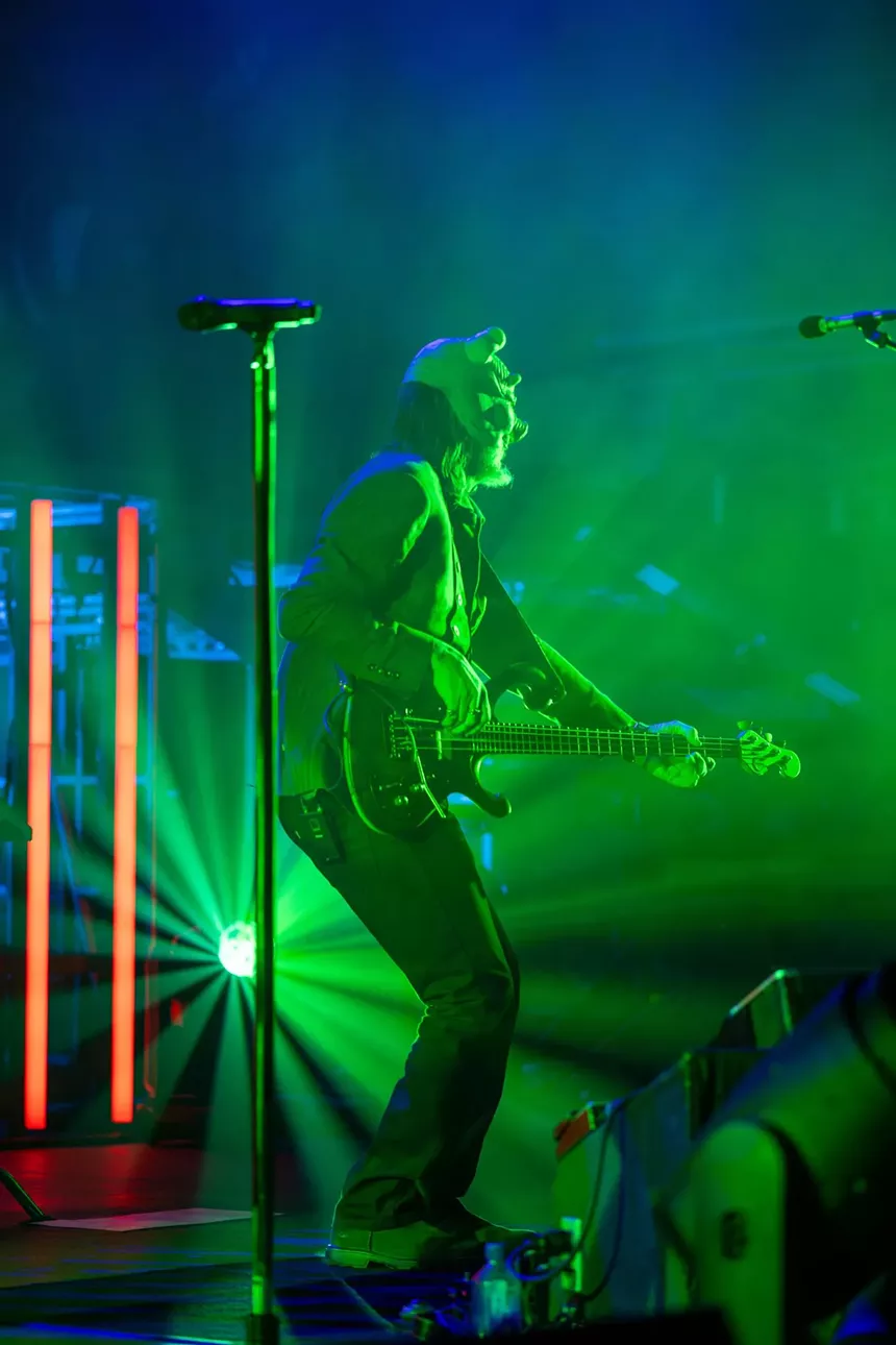 man playing bass in a mask