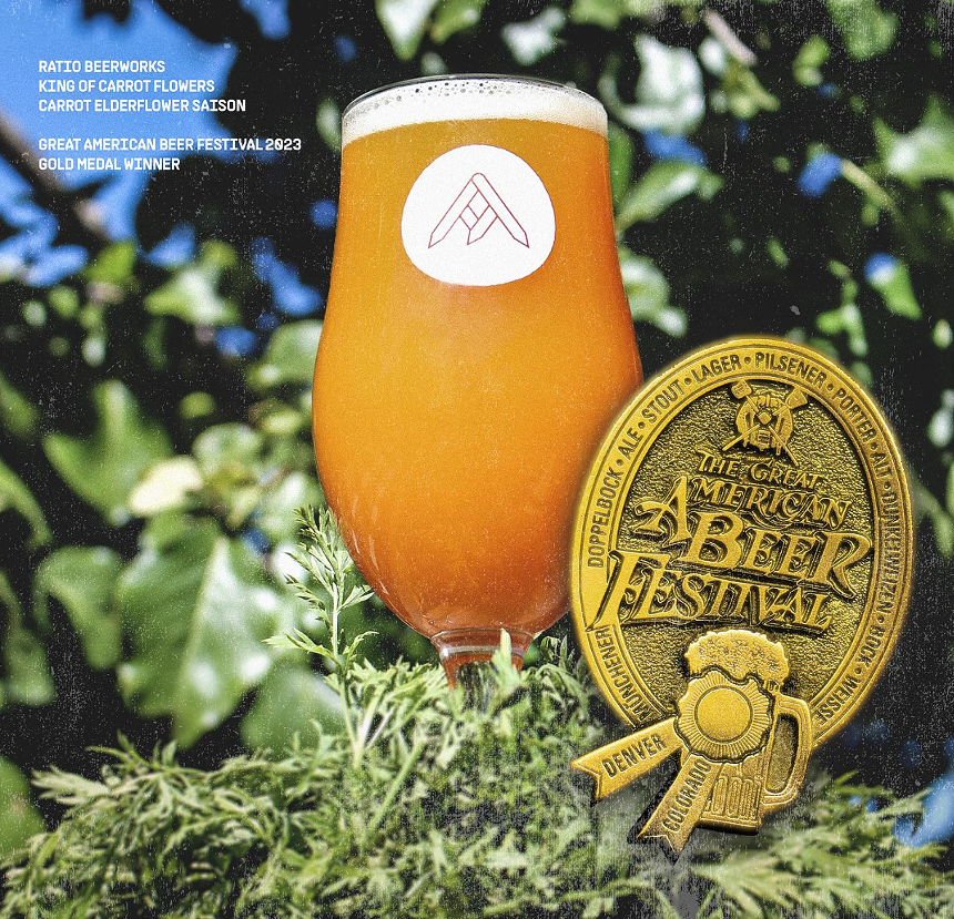 Orange colored beer with a medal.