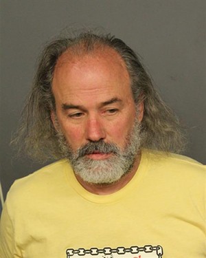police photo of man in yellow shirt