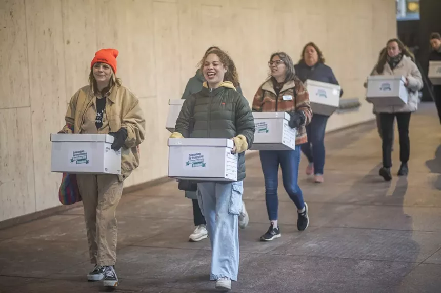 women carrying boxes