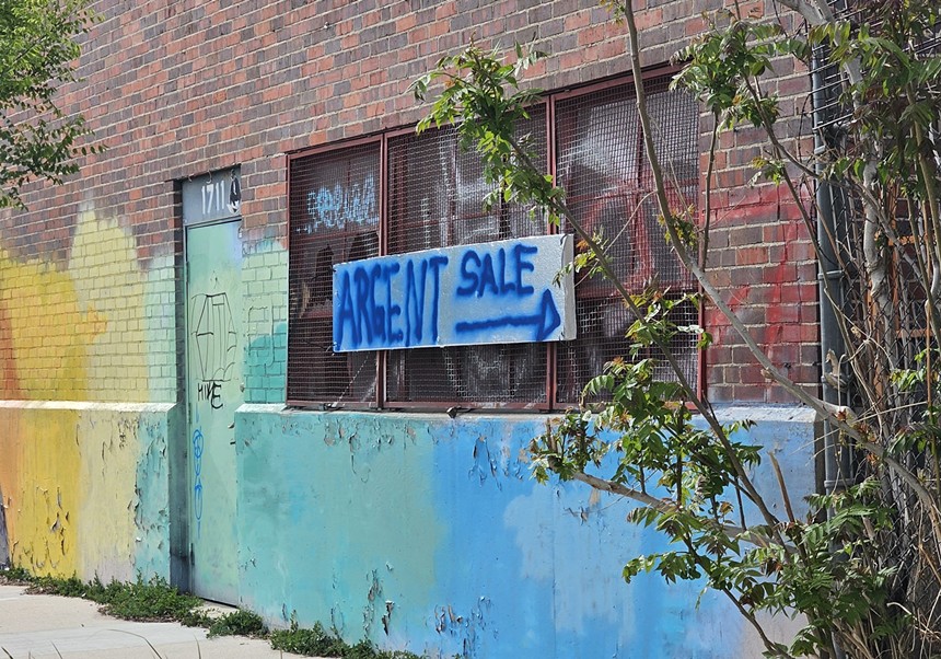sign on painted brick wall