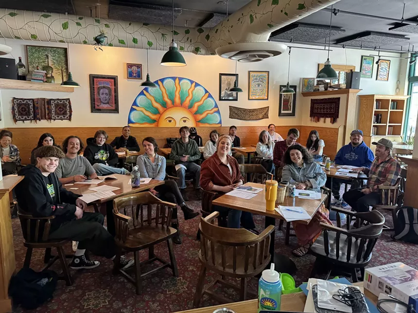 a group of people sitting at tables in a dining room