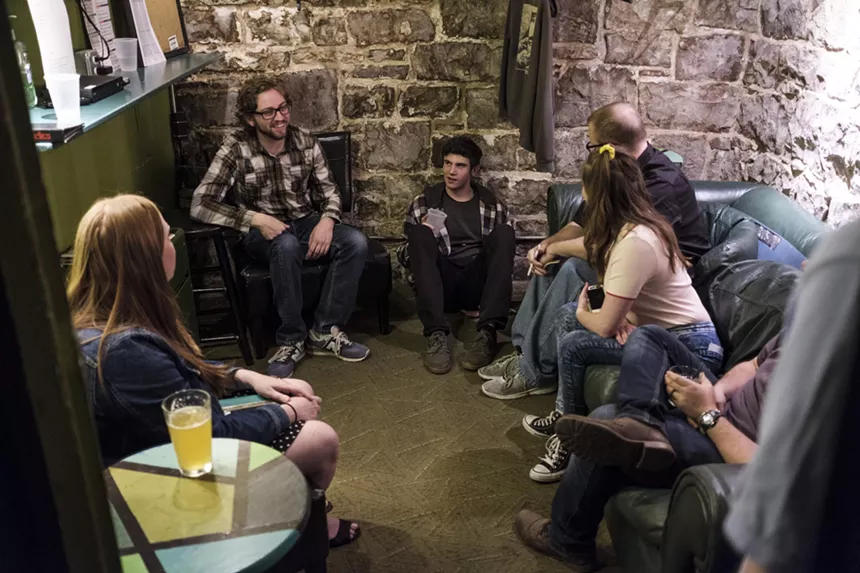 group of people backstage at a comedy club