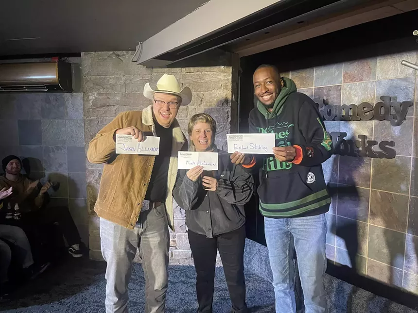 three comedians holding checks