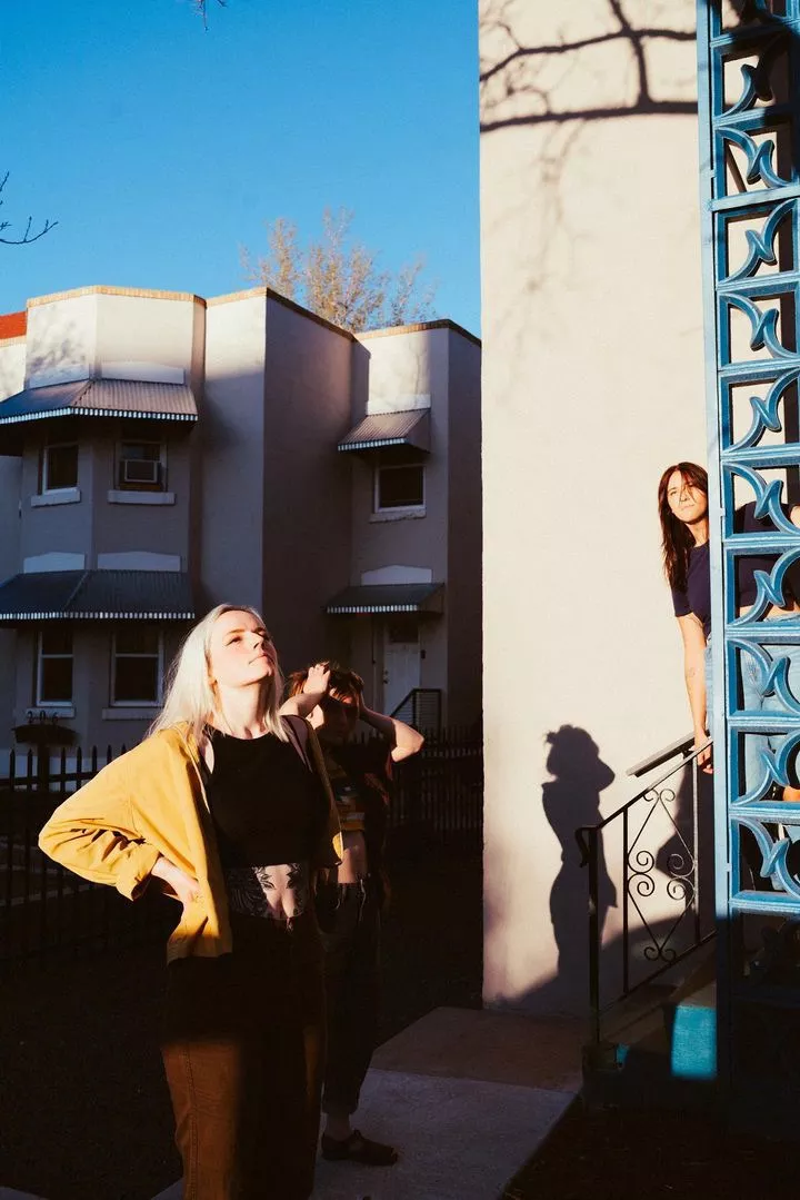 women standing outside a building