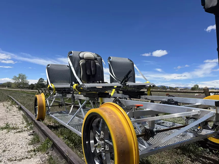 A Colorado-made railbike set on Erie tracks and backdropped by the Front Range