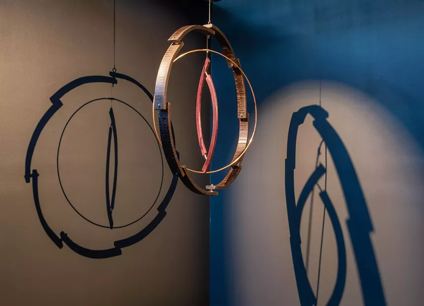 wooden and brass hanging sculpture