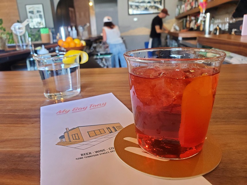 a red cocktail on a bar