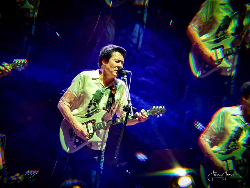 man playing electric guitar