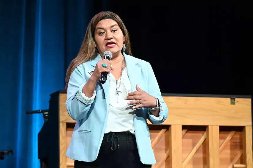 A woman talks on stage.