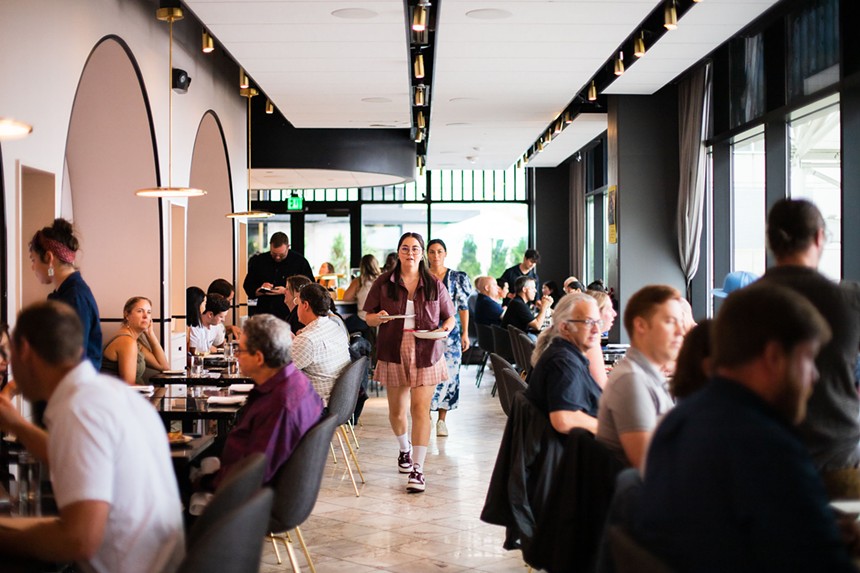 people sitting at tables in a restaurant