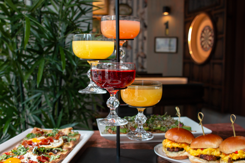 A mimosa tower and brunch plates at Flight Club