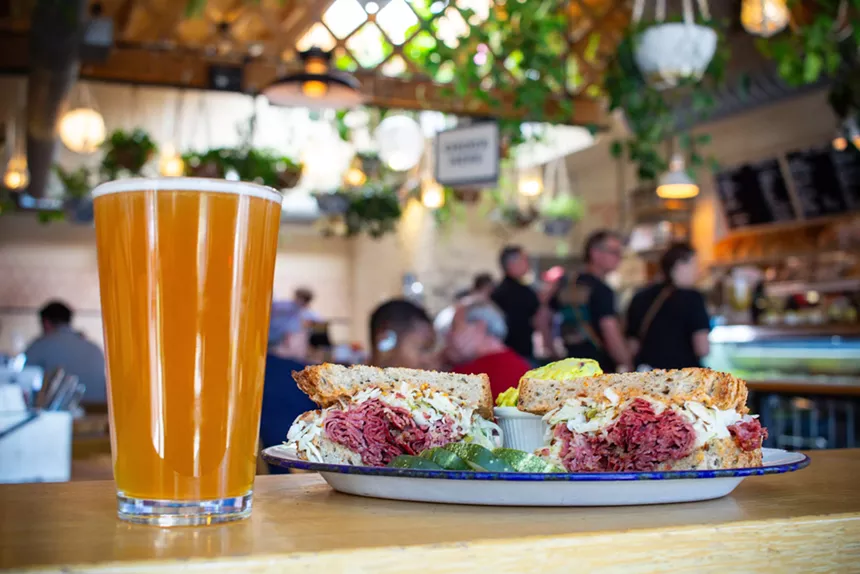 A Reuben sandwich and beer on a counter at Leven Deli Co.