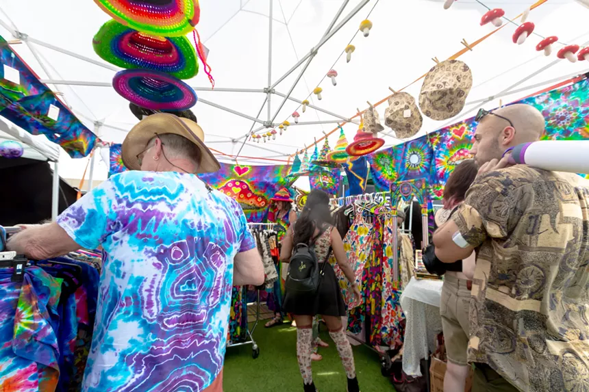 Psychedelic clothing vendor at outdoor market