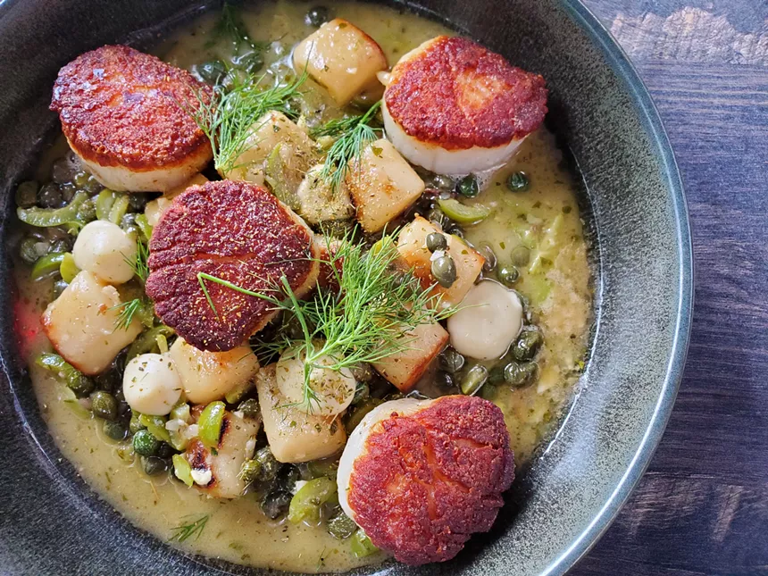 seared scallops in a bowl with gnocchi