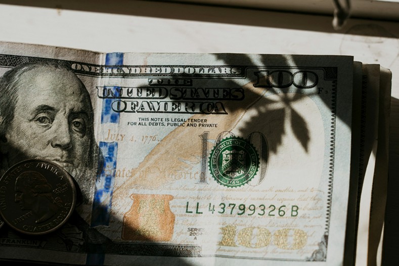 Marijuana leaf on a hundred dollar bill