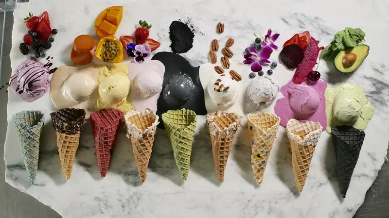 Multiple Heaven Creamery ice cream cones and melting scoops laid flat on a counter