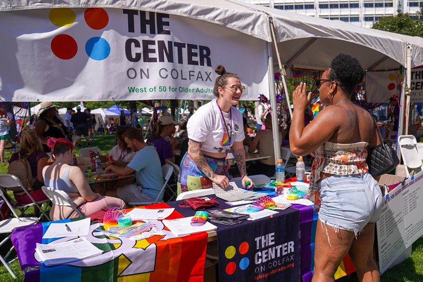 person at a pride booth for the center on colfax