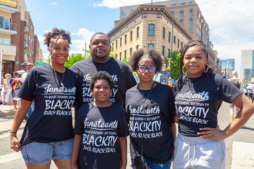 black family in Juneteenth T-shirts outside