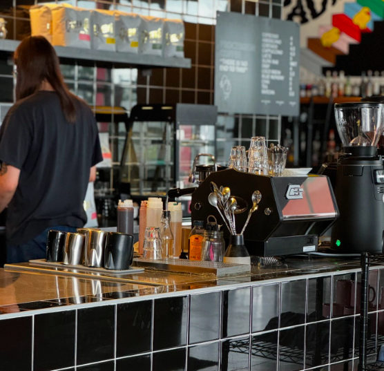 a coffee bar with black tiles