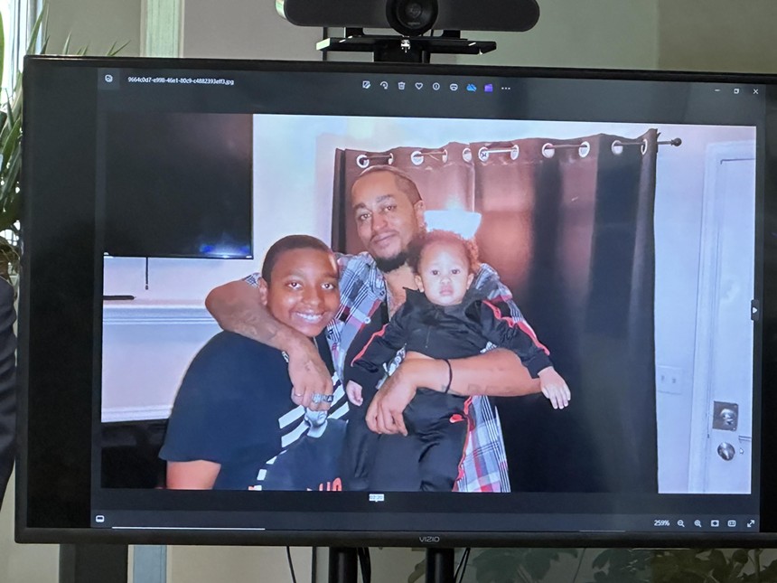Aurora police shooting victim Kilyn Lewis holding his sons in a photo.