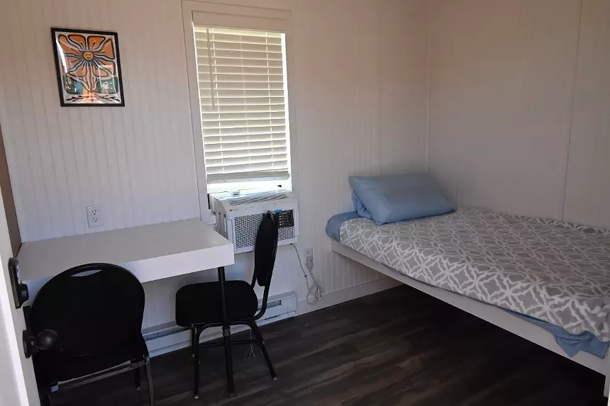 A room has a bed but no bathroom.