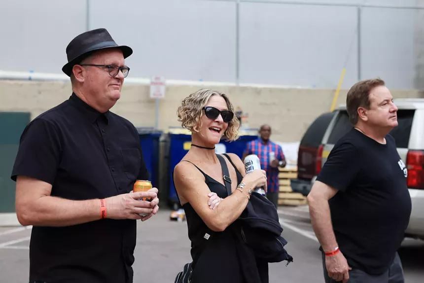 people smiling in a parking lot
