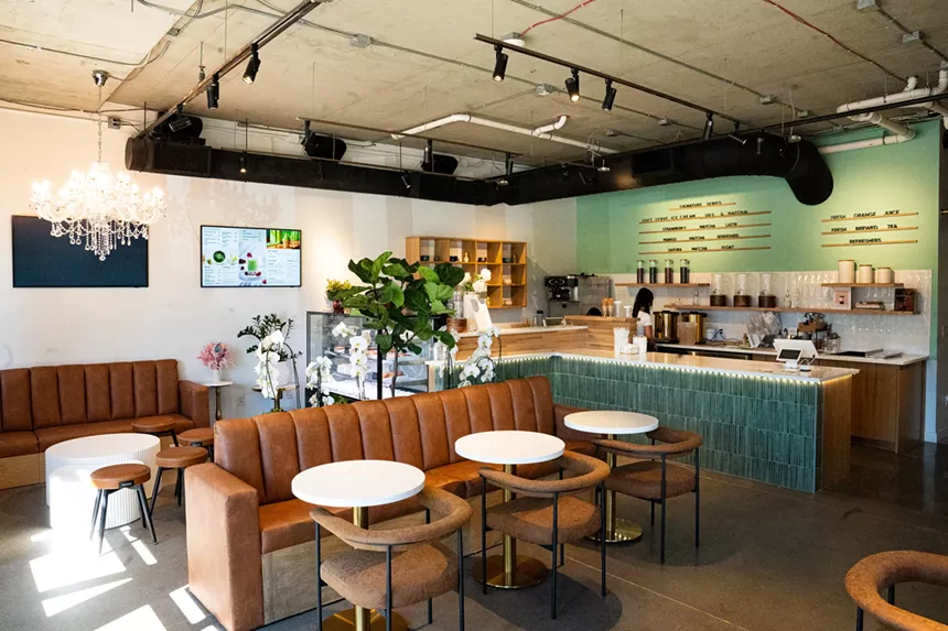 interior of a cafe with brown banquets and teal accents