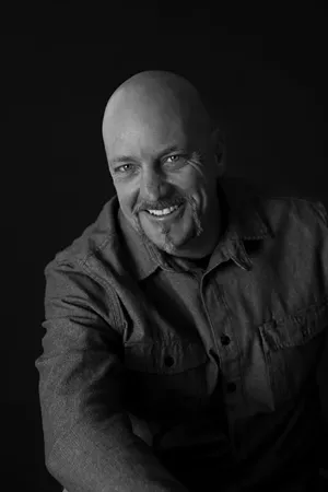 headshot of a bald man