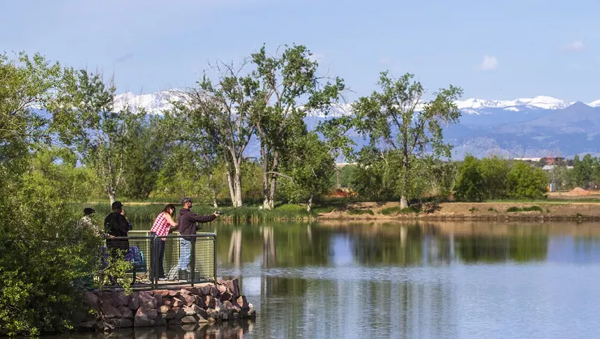 Fisherman cast reel into lake