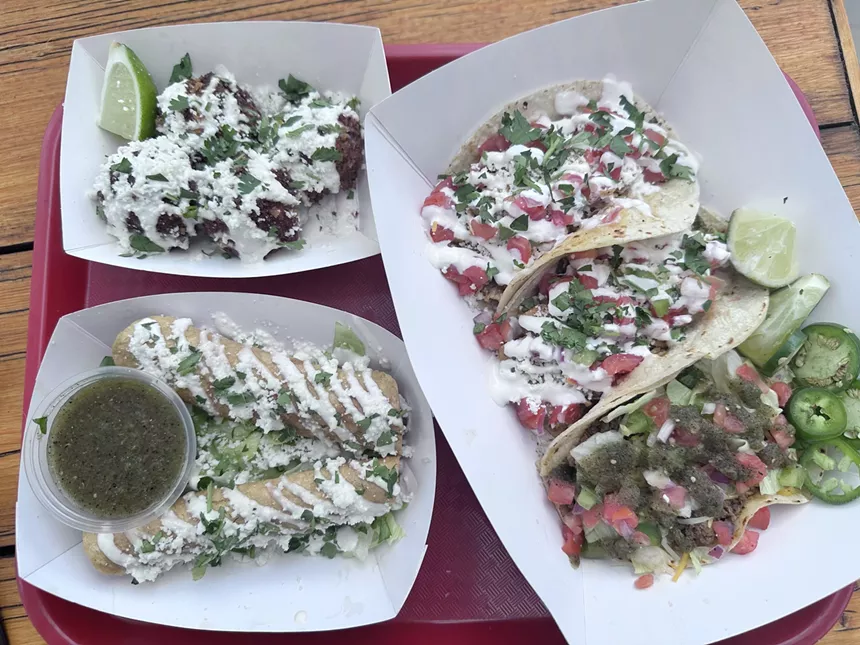 tacos, flautas and elote balls on a tray
