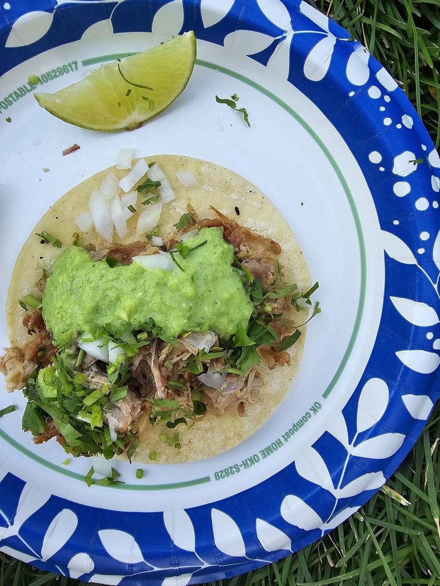 a taco with green salsa