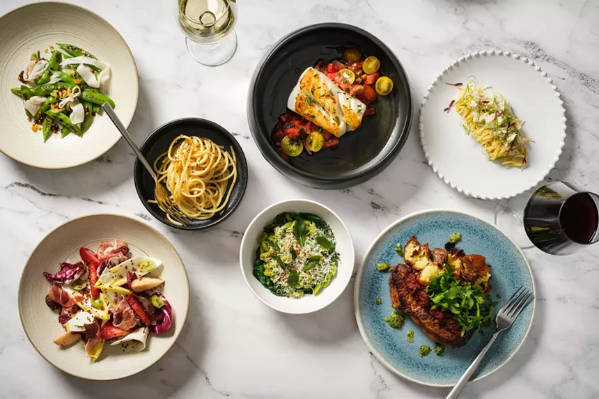 various dishes of food on a white marble tabletop