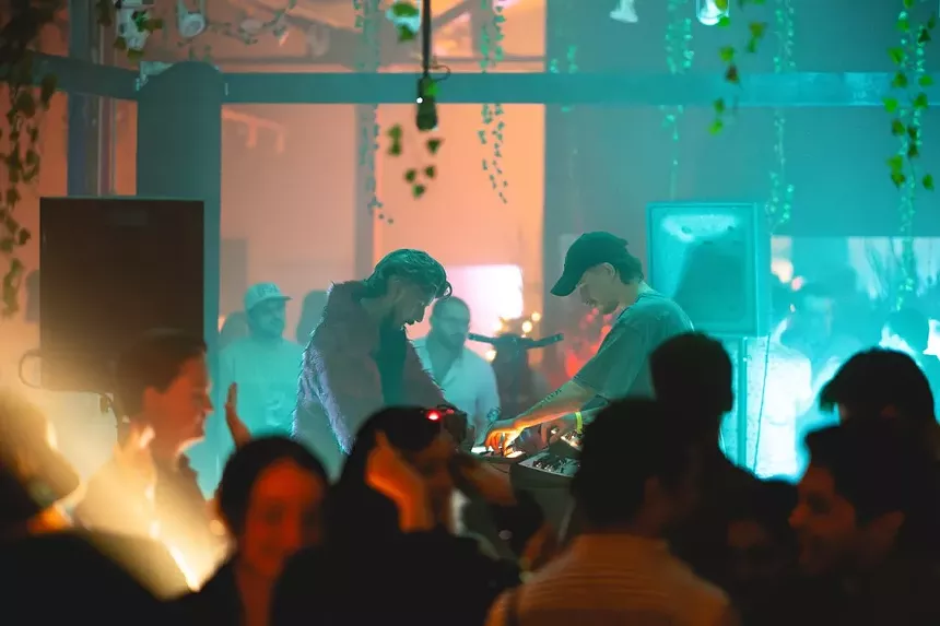 two djs performing