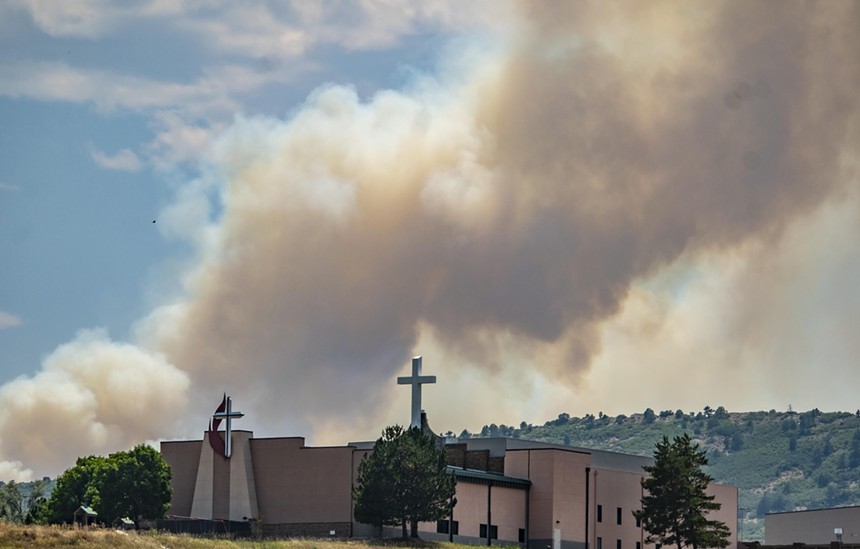 Church with wildfire burning in the background