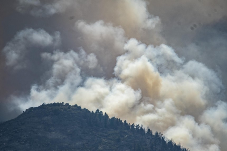 Wildfire burns behind mountain