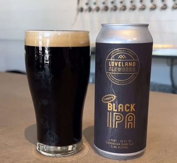 Black beer and black can side by side.