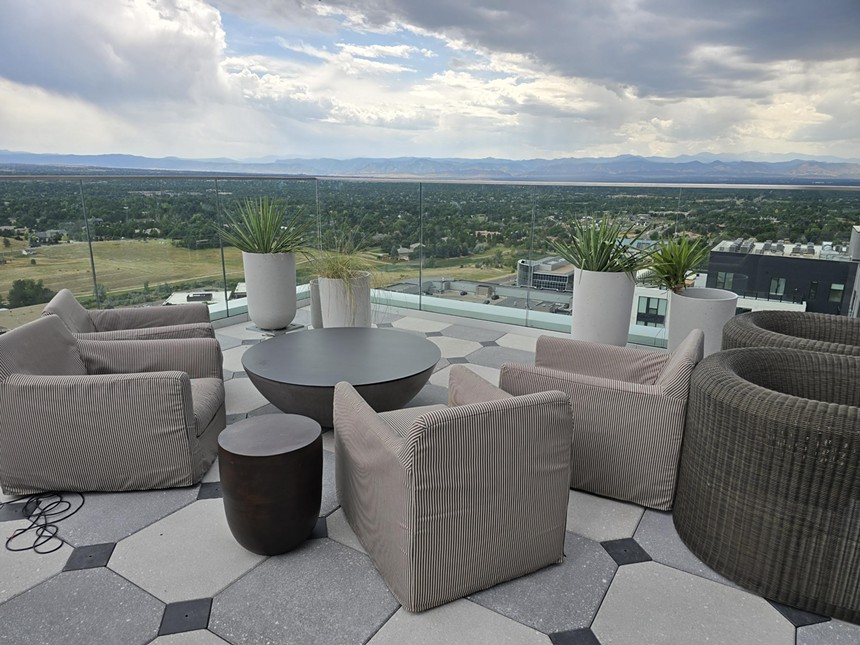 table and chairs overlooking mountains in the distance