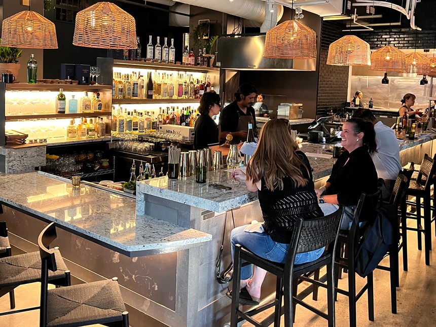 two women sitting at a bar