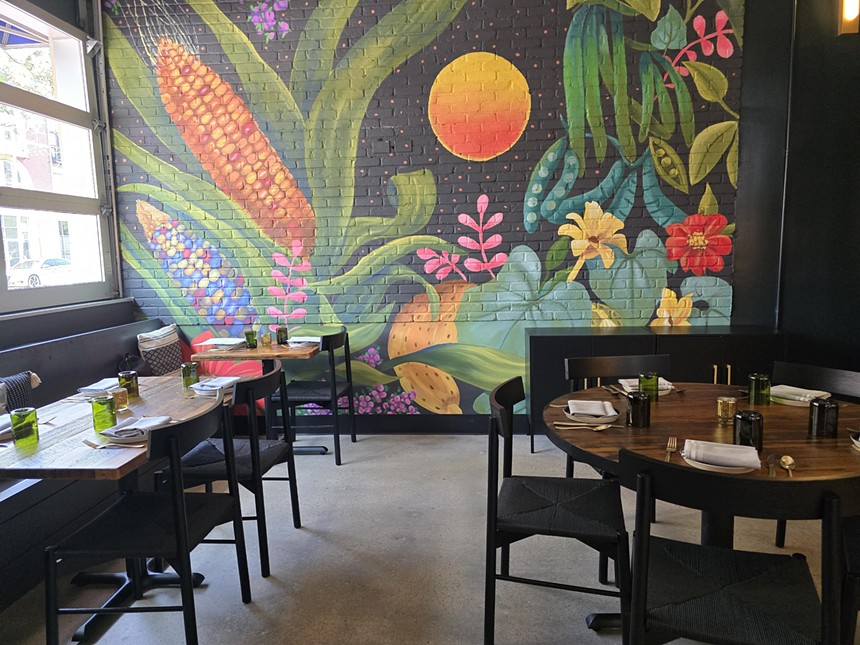 a colorful mural on an interior wall in a restaurant