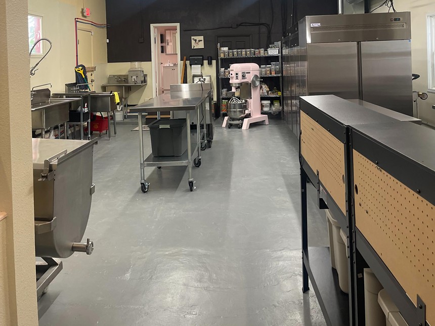 a production kitchen with a large pink mixer
