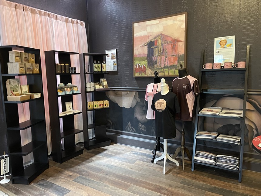 shelves and three manequins with shirts in a retail space