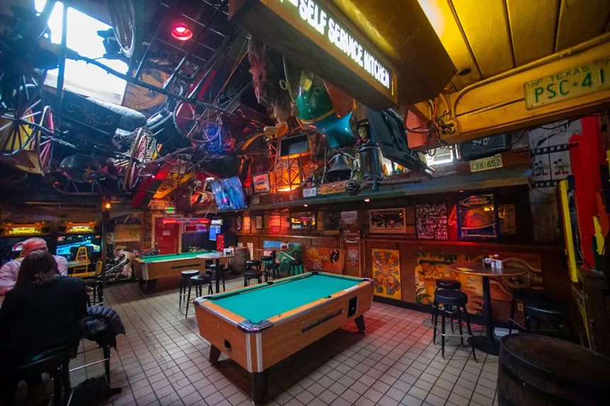 A pool table in a dark bar