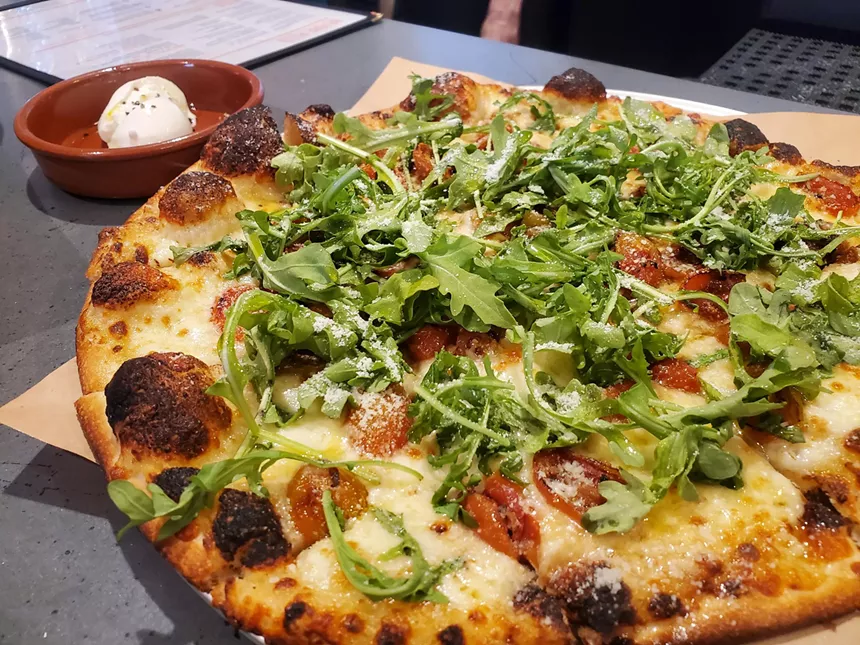 pizza with arugula on top